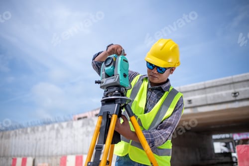 Preview: Engineers Surveyor wearing safety uniform ,helmet with equipment theodolite to measurement positioni