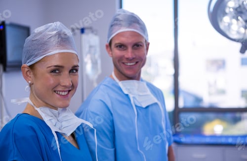 Preview: Portrait of male and female nurse smiling in operation theater