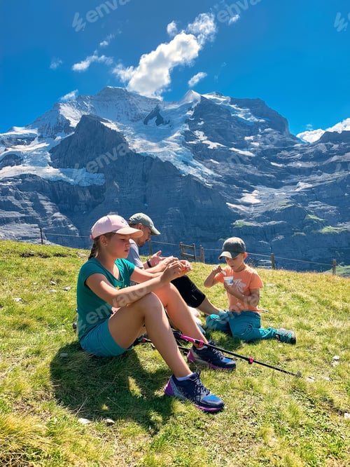 Preview: Family having a rest hiking in the mountains