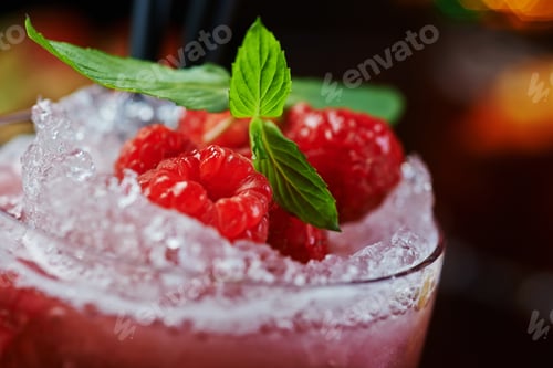 Preview: bright glass of alcoholic cocktail or lemonade on a table in a bar. soft focus.
