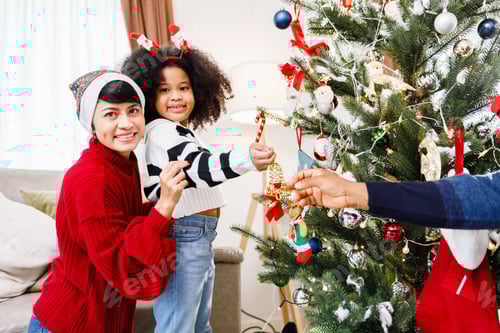 Preview: Family Decorating a Christmas Tree in Cozy Home