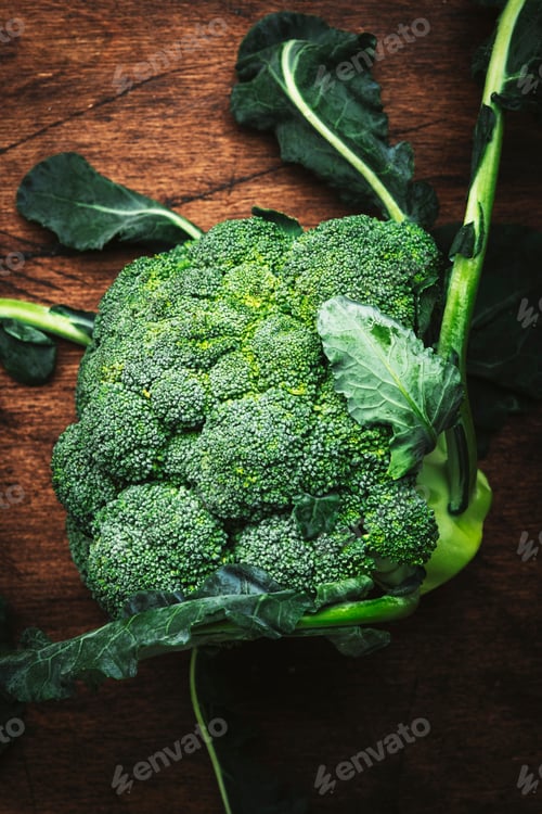 Preview: Fresh organic broccoli cabbage on old rustic wooden kitchen table background, top view