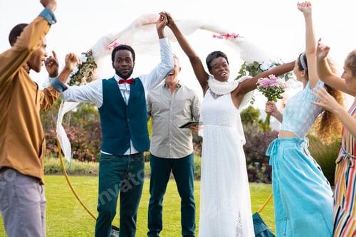 Preview: Portrait of happy african american couple holding hands during wedding