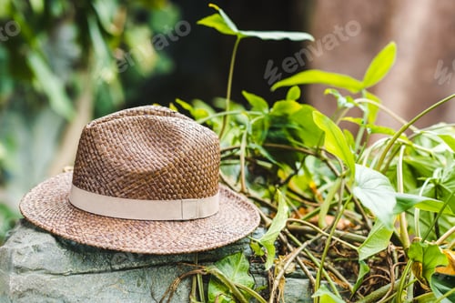 Preview: vintage brown straw hat on rock in jungle