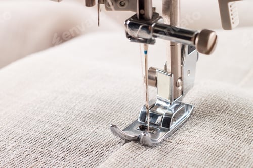 Preview: Close-up of modern sewing machine presser foot and needle sewing item of clothes.