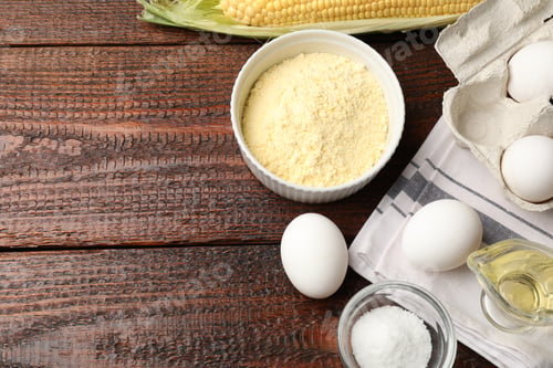 Preview: Different ingredients for corn bread on wooden table, flat lay. Space for text