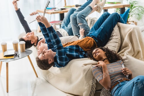 Preview: teens lying on sofa and taking selfie with tablet and smartphone