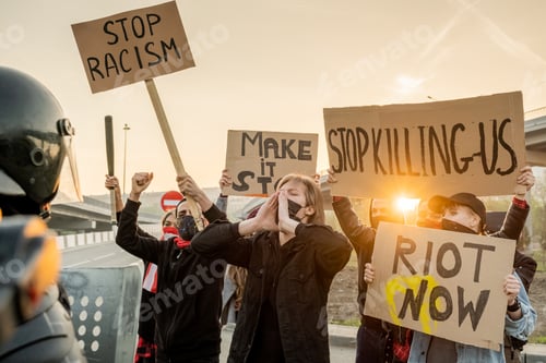 Preview: Activists holding signs at rally in protest