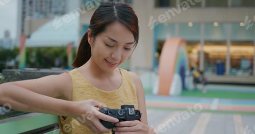 Preview: Woman use camera to take photo at outdoor