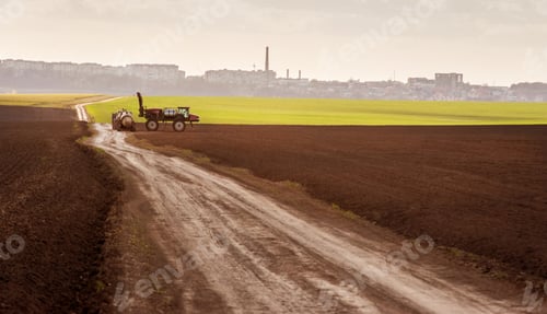 Preview: sprayer in the arable field at refueling near dirt road