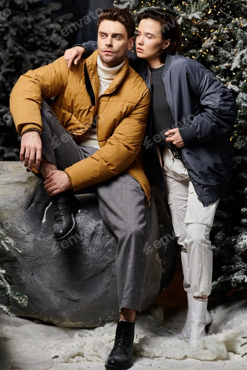 Preview: A couple enjoys winter magic amid snow-covered pines in a cozy setting