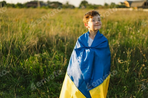 Preview: Ukrainian child boy in white t shirt with yellow and blue flag of Ukraine in field.