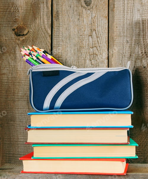 Preview: Books and school tools on a wooden shelf.