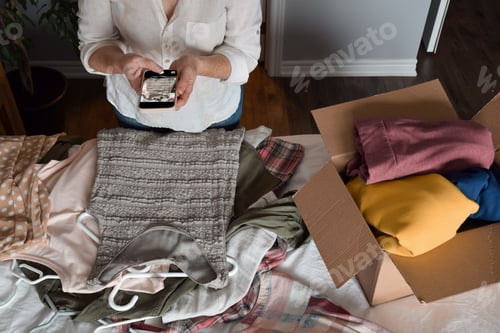 Preview: Woman is taking a picture of her unwanted clothing items to resale online
