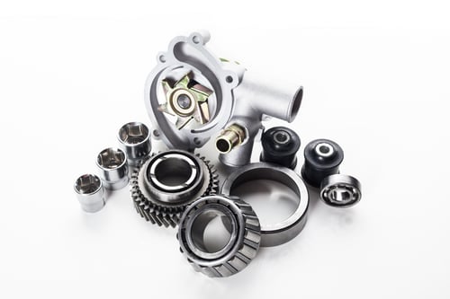 Preview: Collection of automotive engine parts arranged artistically on a light background showcasing