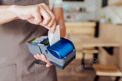 Preview: cropped shot of waiter receiving payment with credit card and terminal