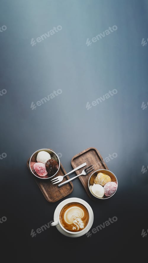 Preview: Top view of a mochi served with a cup of coffee on a gray background