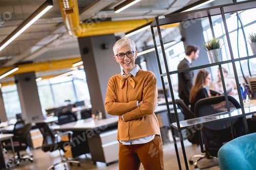 Preview: Senior businesswoman standing in office