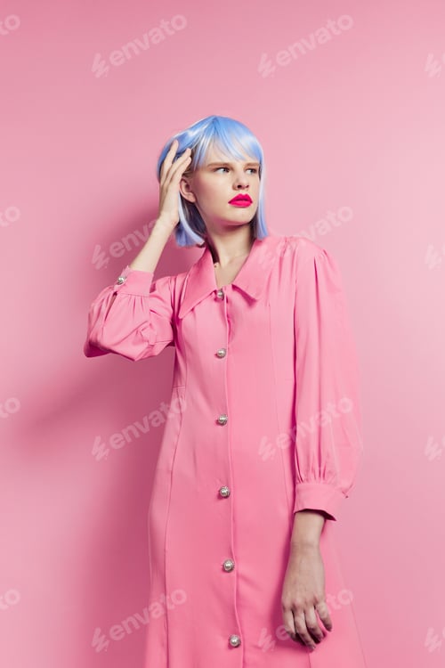 Preview: glamorous woman wears a blue wig makeup pink background