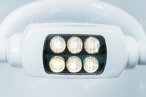 Preview: close up of modern surgical lamps with lights in dental clinic