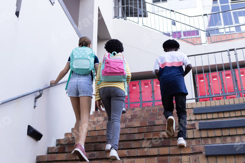 Preview: Walking up stairs, three diverse students with backpacks heading to school lockers