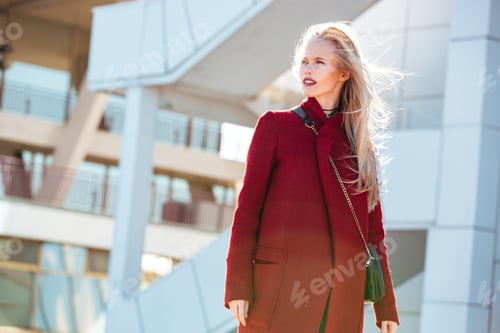 Preview: Young caucasian woman walking outdoors