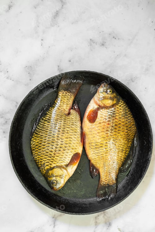 Preview: The fish are golden with distinct scales and fins, ready for cooking