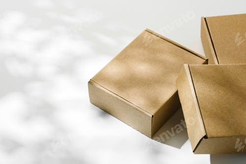 Preview: Three brown cardboard boxes arranged on a light surface with soft shadows
