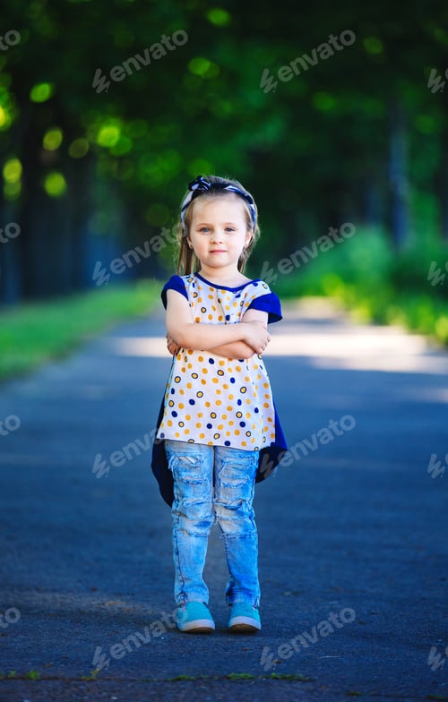Preview: Cute little girl is having fun, jumping and laughing outdoors. happy childhood