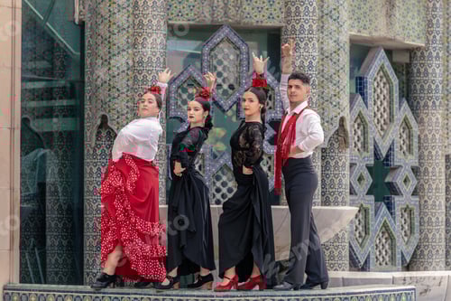 Preview: young apprentice flamenco dancers pose in front of a Mudejar-style fountain