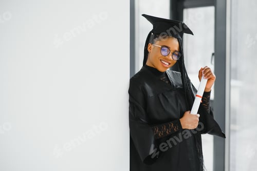 Preview: happy african american female student with diploma at graduation