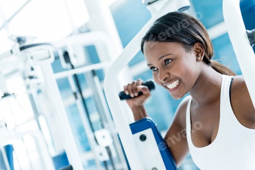 Preview: Gym Woman Exercising On A Machine And Looking Happy