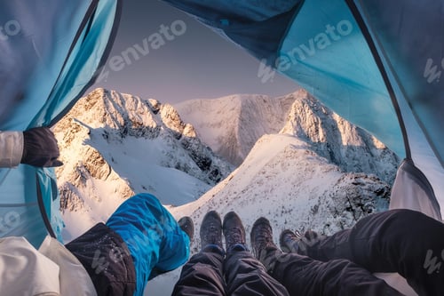 Preview: Group of climber are inside a tent with open for view of blizzard on mountain