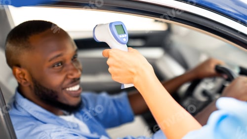 Preview: Medical Worker Checking Body Temperature Of Black Man In Car