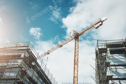Preview: Is it a bird Is it a plane No, its a crane. Shot of a crane and building at a construction site.