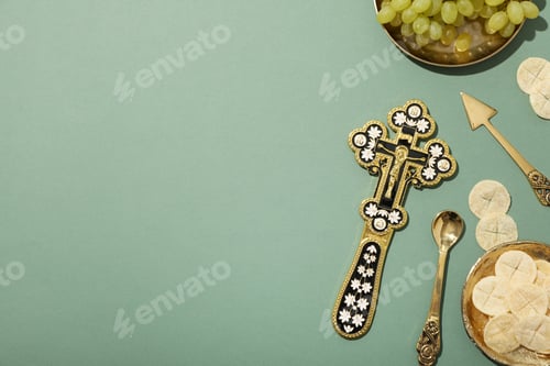 Preview: Liturgical bread, cross and grapes on green background, space for text