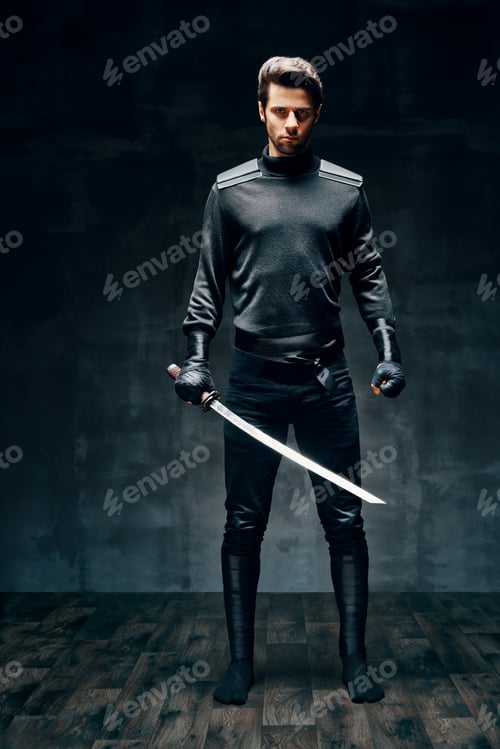Preview: Full length portrait of warrior man posing with a sword