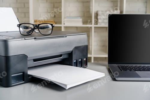 Preview: Printer and laptop on grey table in office