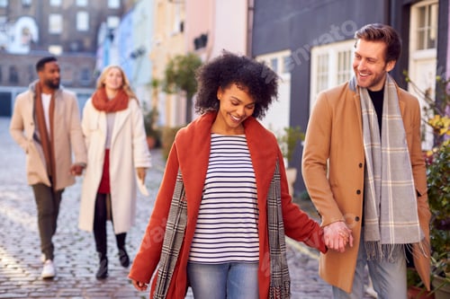 Preview: Multi Cultural Couple With Friends Walking Along Residential City Street In Fall Or Winter