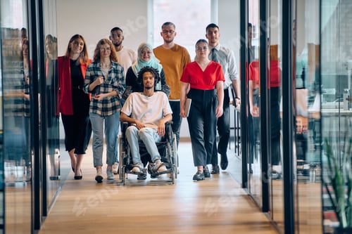 Preview: A diverse group of young business people congregates within a modern startup's glass-enclosed office