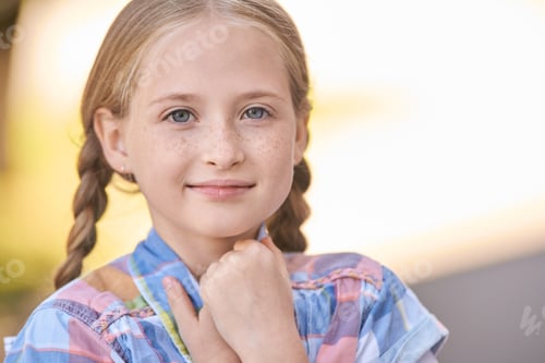 Preview: Young caucasian girl with braided hair smiling outdoors in plaid shirt