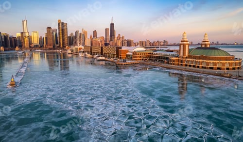 Preview: Aerial Chicago skyline at sunrise with a view of the navy pier and frozen lake Michigan