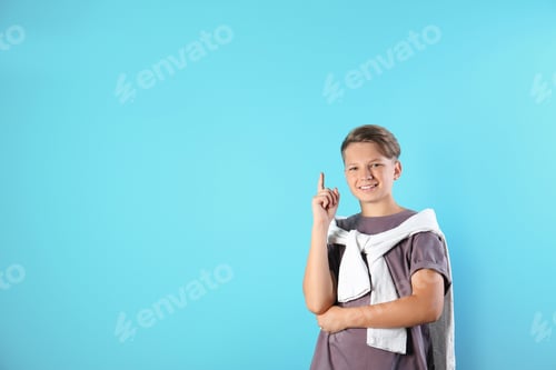 Preview: Teenage boy in casual clothes on color background