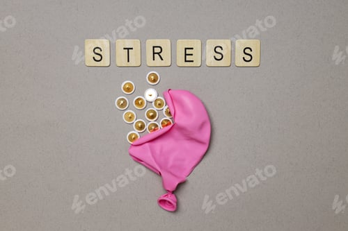 Preview: Bursting balloon and word Stress on gray background, top view