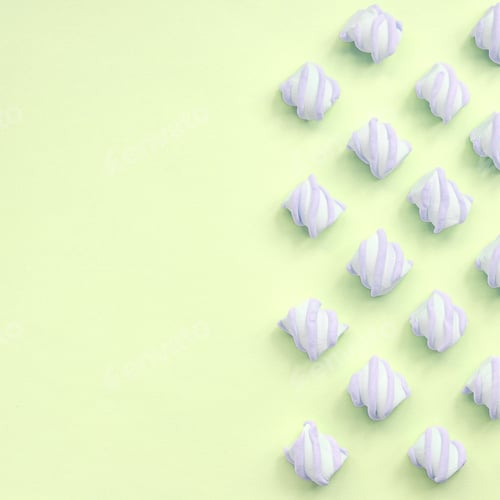 Preview: Colorful marshmallow laid out on lime paper background. pastel creative textures