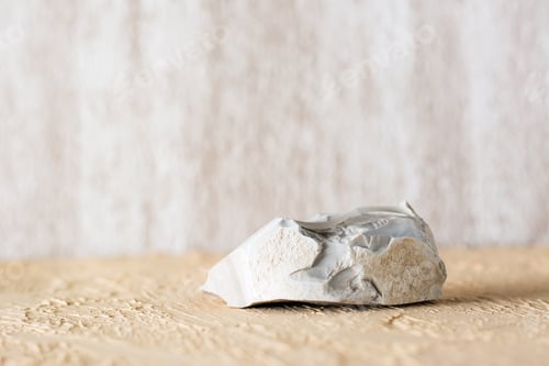 Preview: Natural stone on a beige textured plaster surface