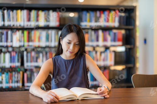 Preview: Woman read the book in library