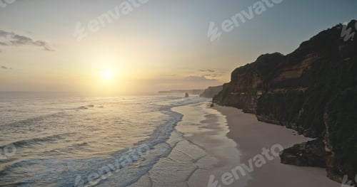Preview: Sun sunrise at ocean waves with cliff sand beach aerial view. Nobody tropic nature seascape scenery