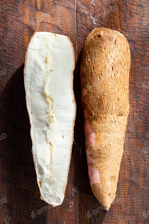 Preview: cassava pile, yucca, on a background of rustic wood (Manihot esculenta)