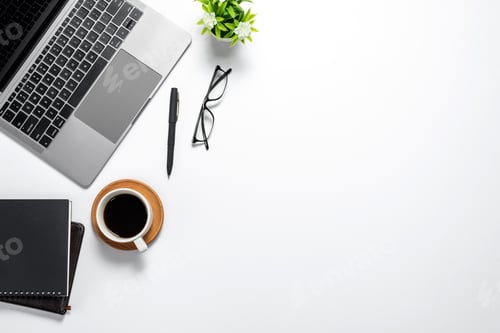 Preview: Modern white desk with a coffee laptop glasses notebook top view copy space.
